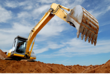 Yellow excavator in sand pit located in Cheyenne, WY