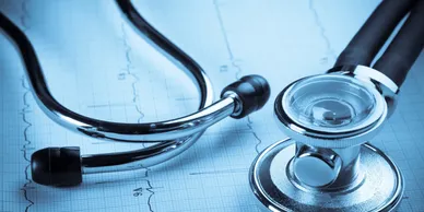 A stethoscope is sitting on top of a medical chart.