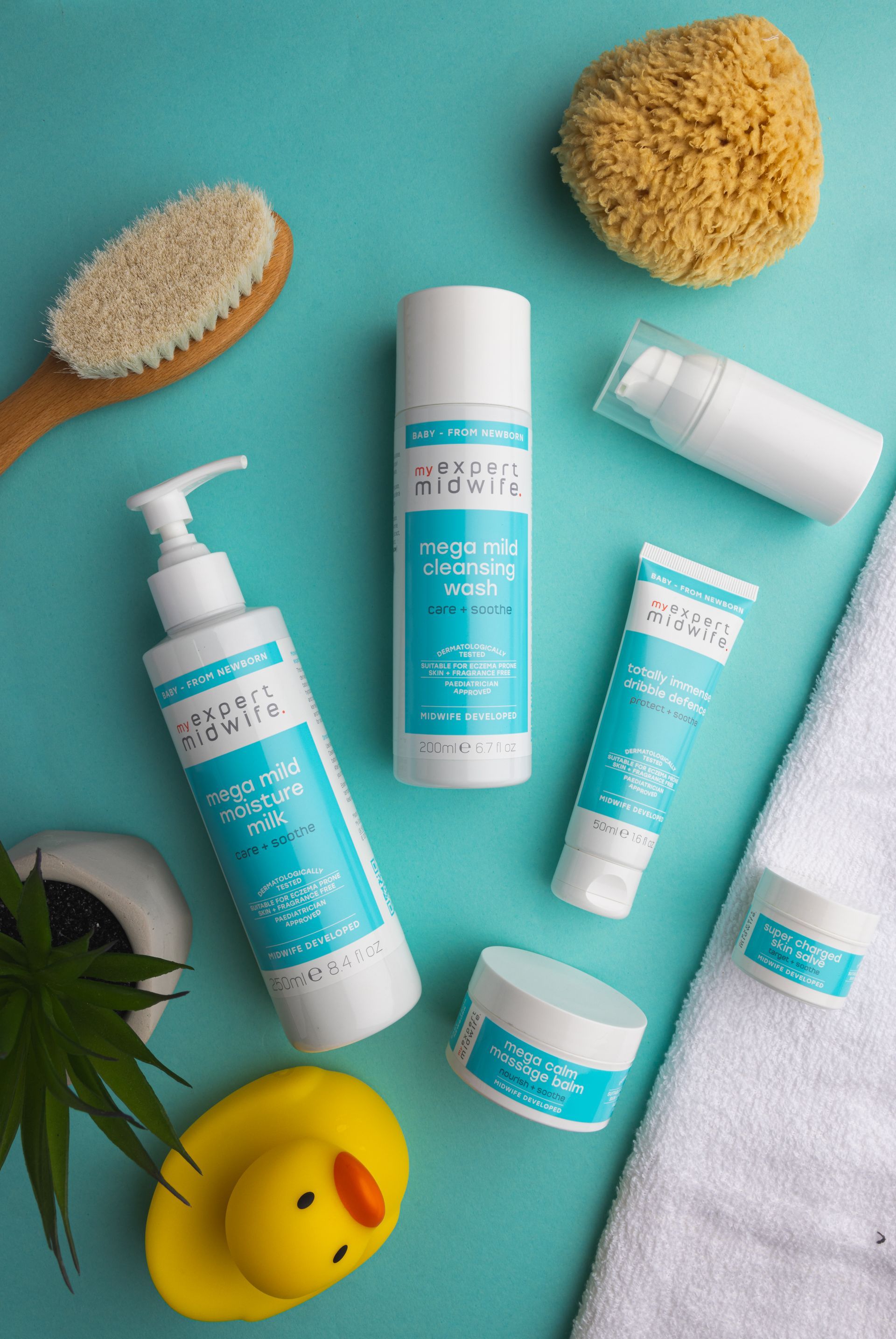 A variety of baby products are sitting on a blue table.