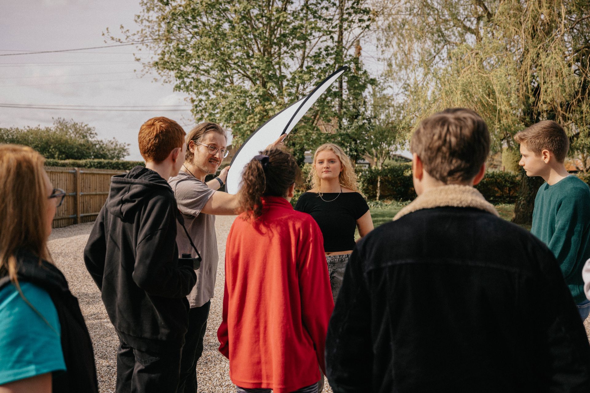 A group of young people are standing in a circle.