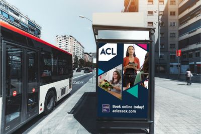 A bus stop with a sign that says acl on it