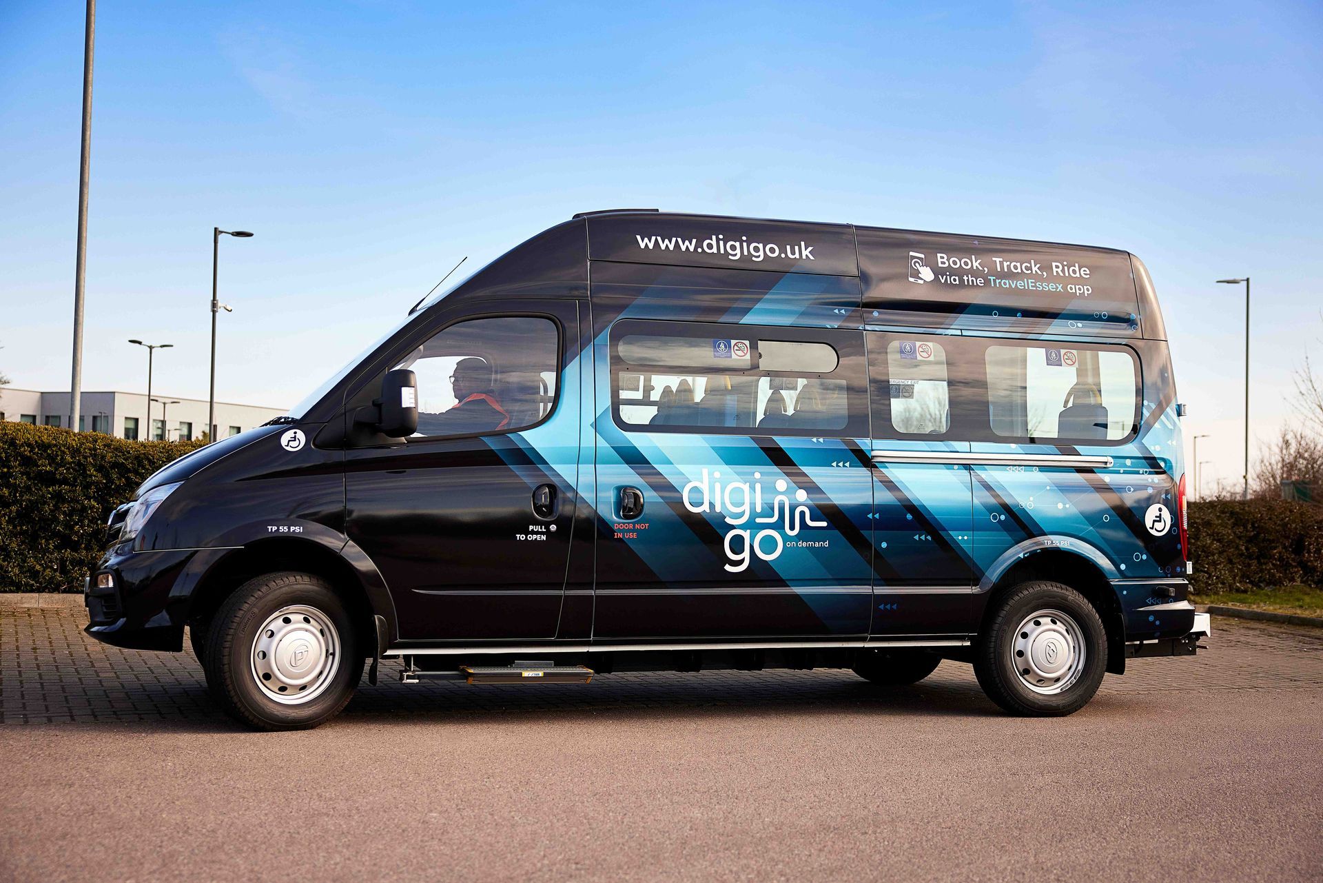 A black van with a digital go sticker on the side is parked in a parking lot.
