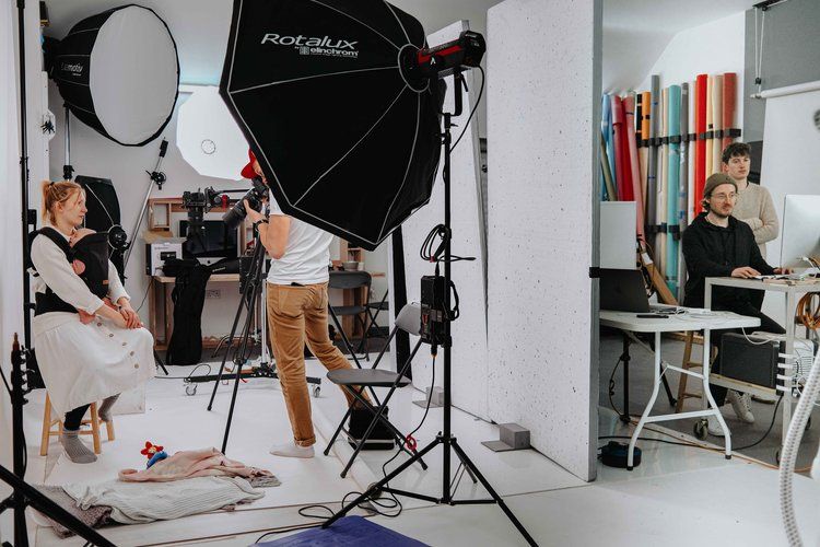 a man is taking a picture of a woman in a photo studio .