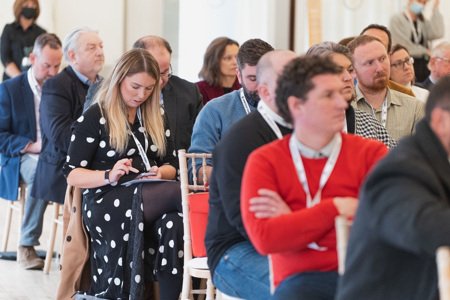 a group of people are sitting in chairs at a conference .