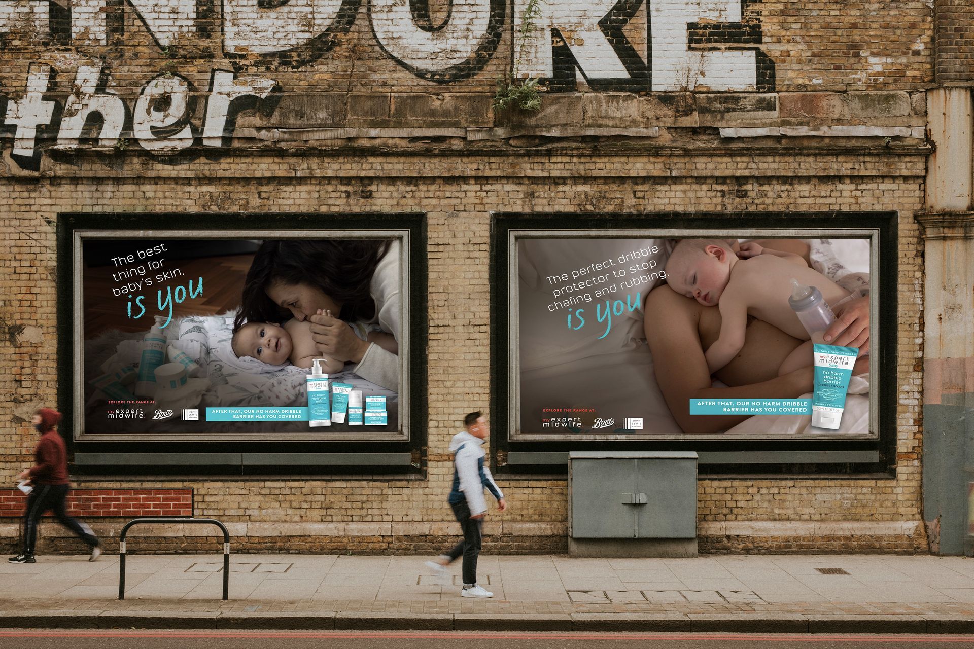 a woman is walking past two billboards on the side of a building .
