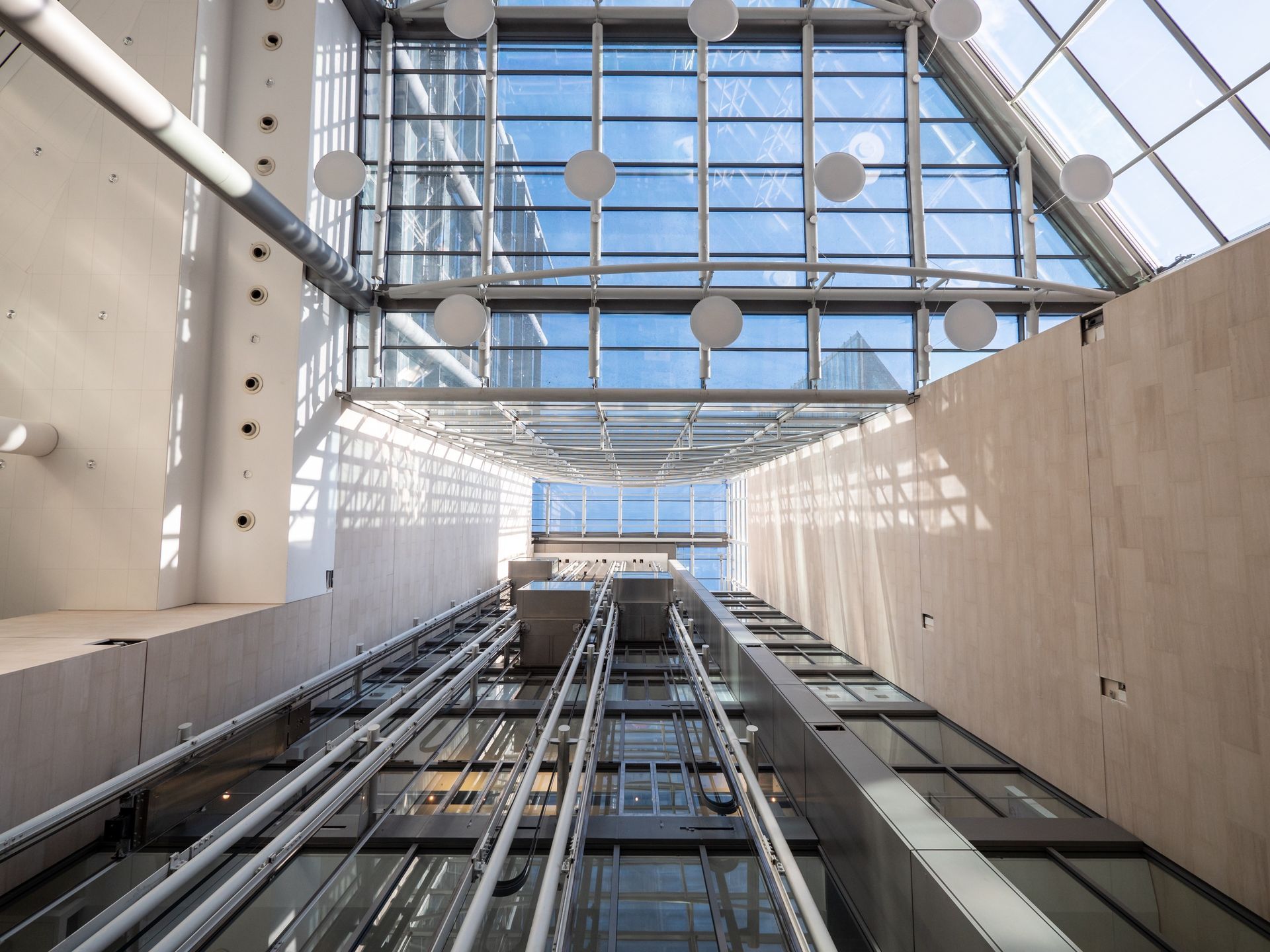Looking up at the ceiling of an elevator in a building.