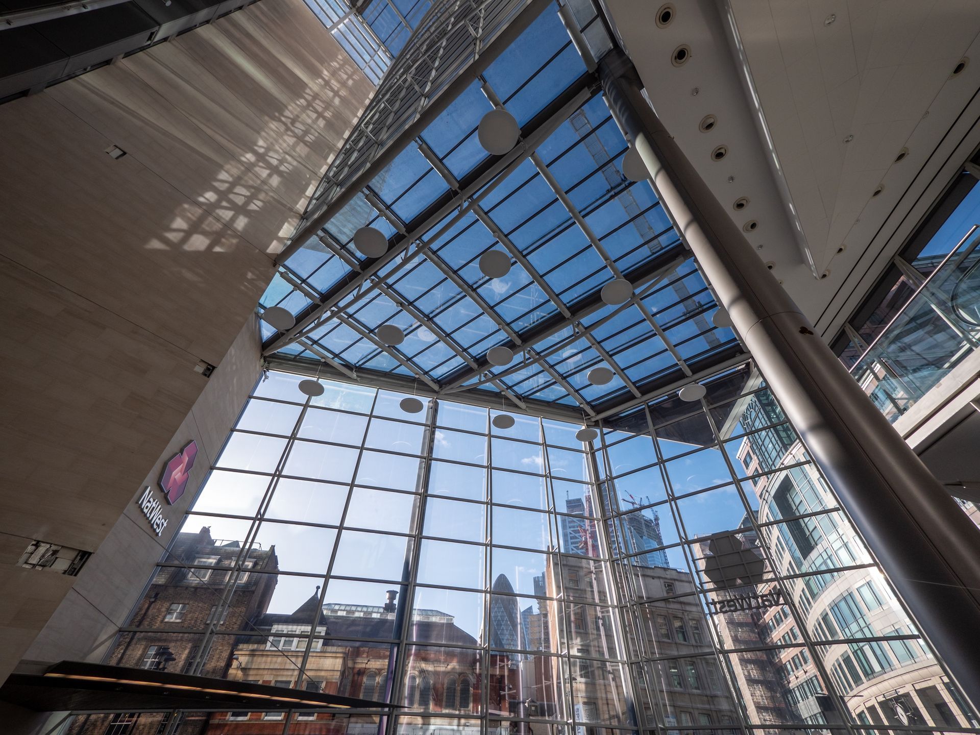 Looking up at the ceiling of a building with lots of windows