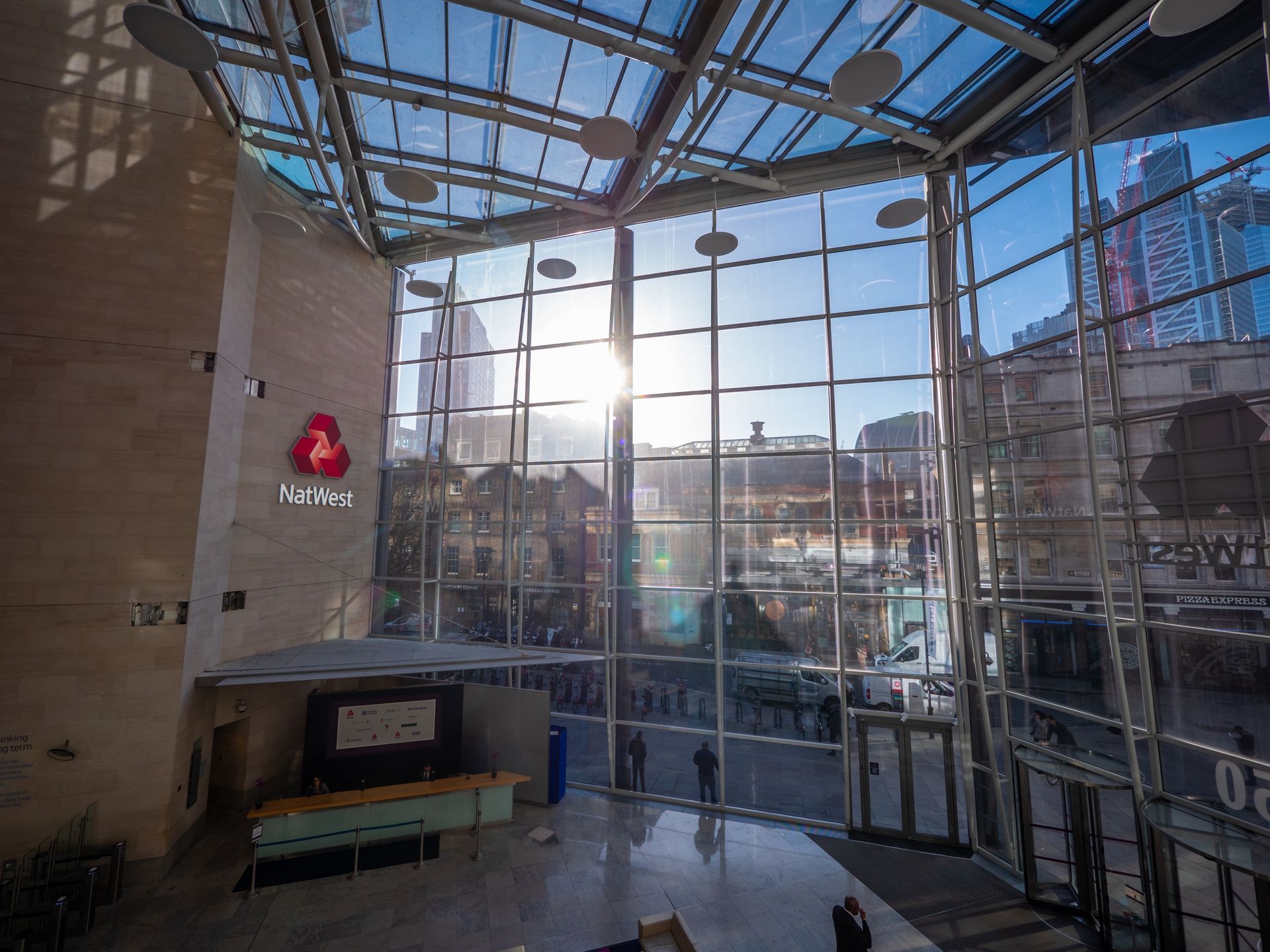 The sun is shining through the windows of a building.