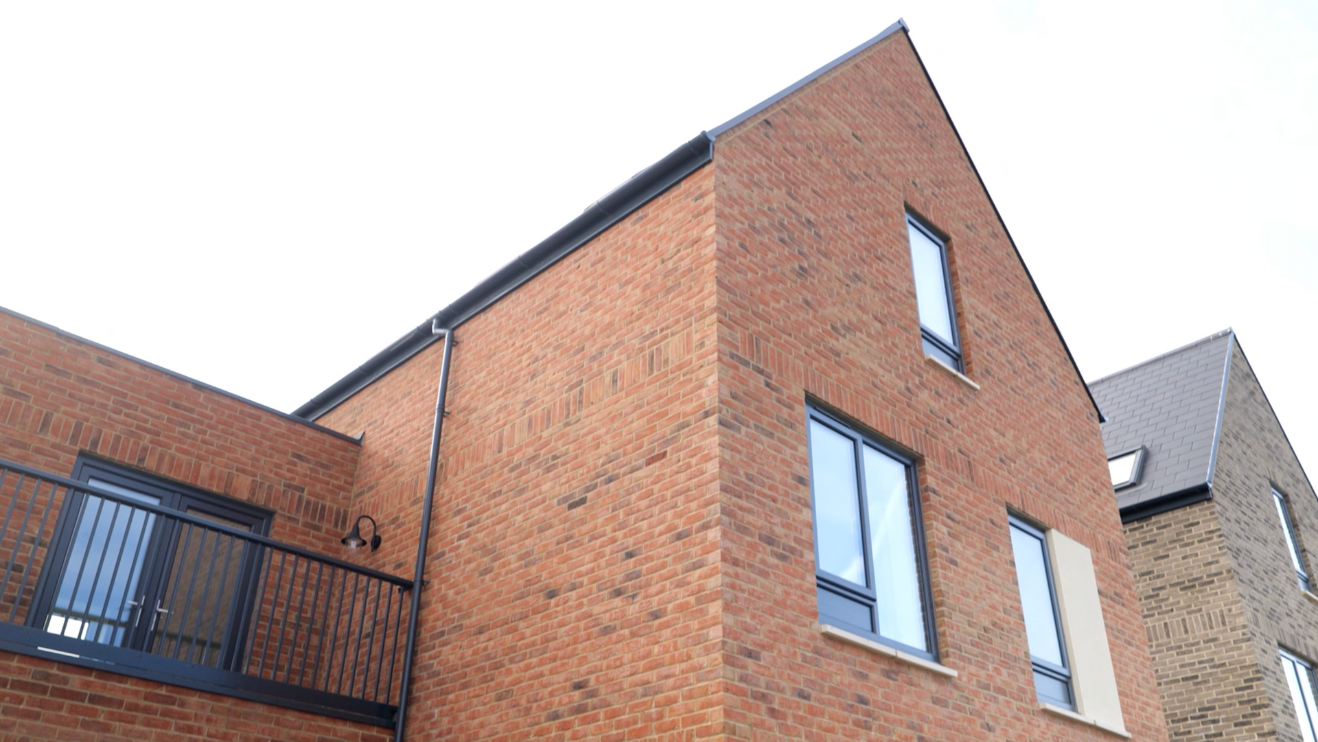 A brick building with a balcony on the side of it.