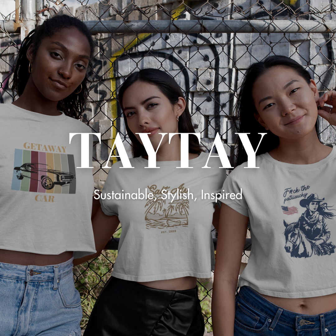 Three women are standing next to each other in front of a chain link fence.