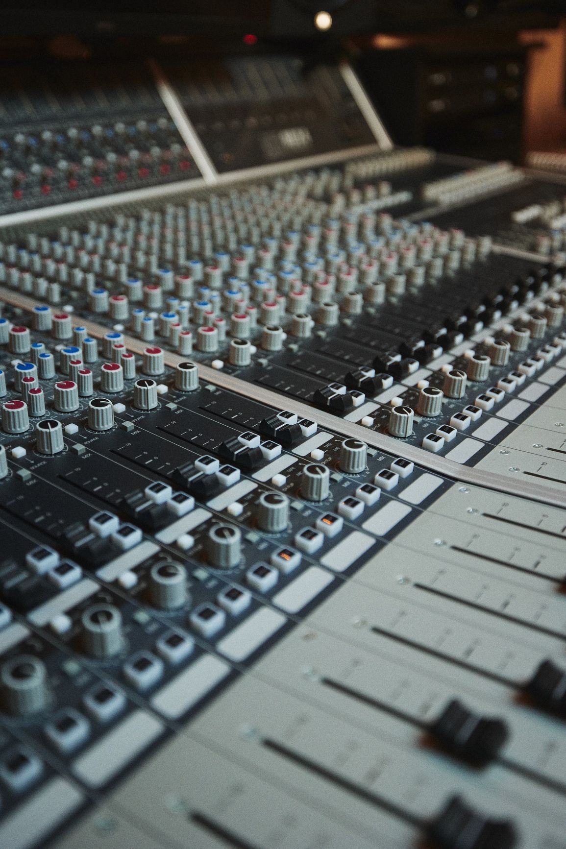 A close up of a mixer in a recording studio.