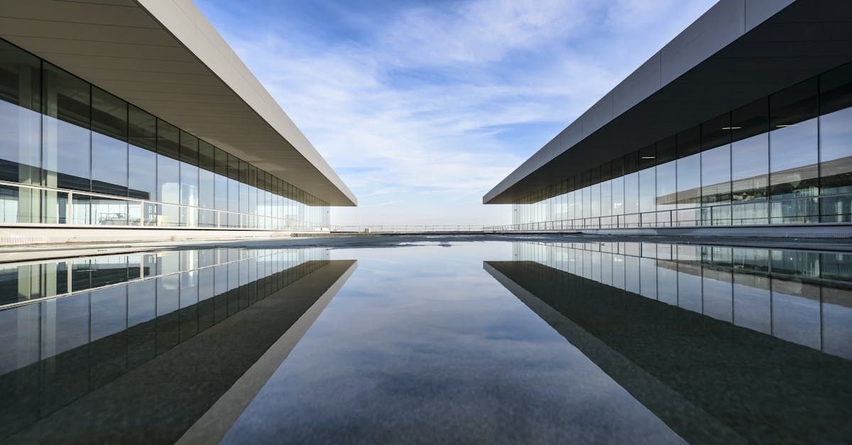 A large building with a reflection of it in the water.