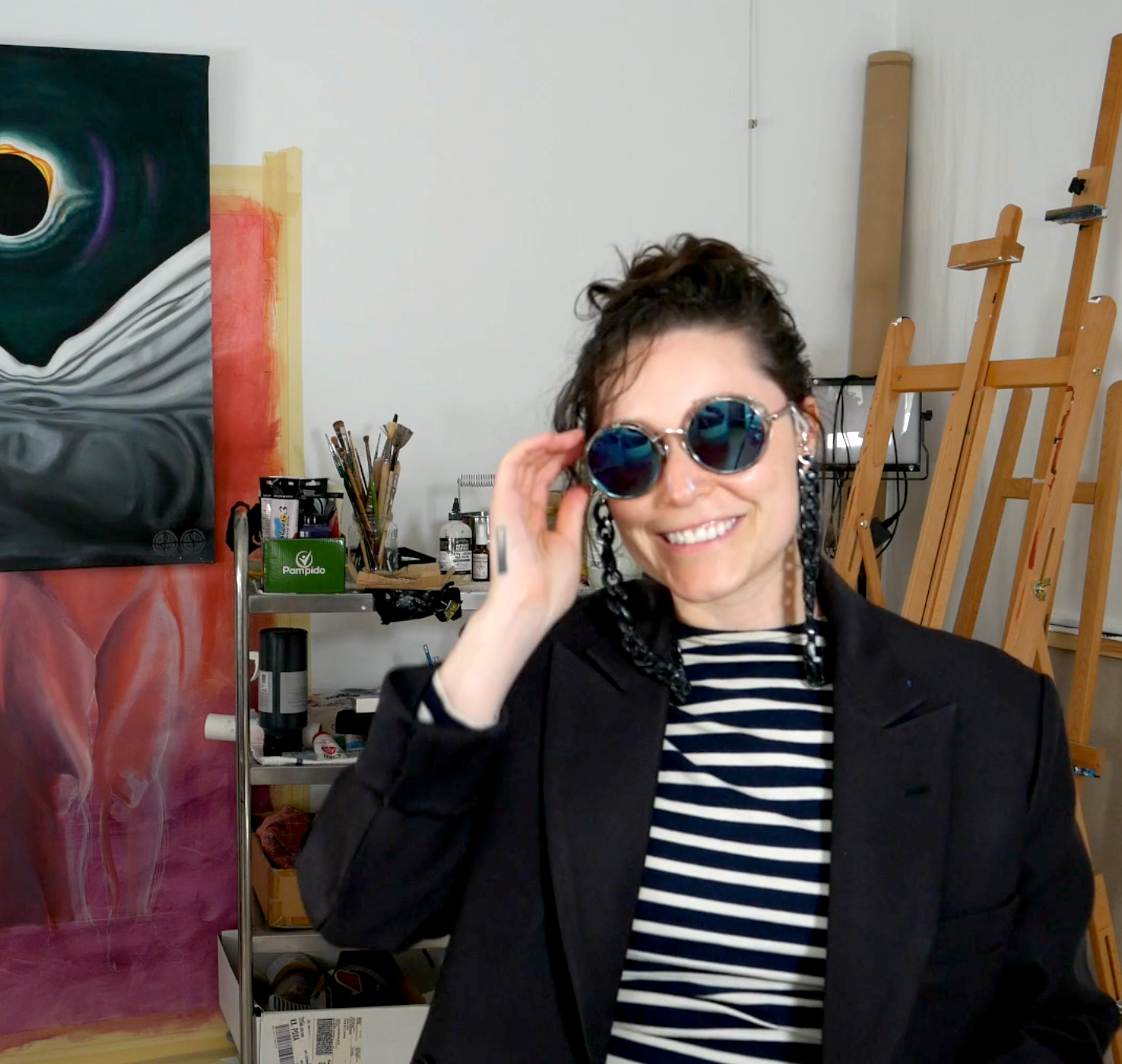 Lala Drona the artist touching her sunglasses when they are on her face