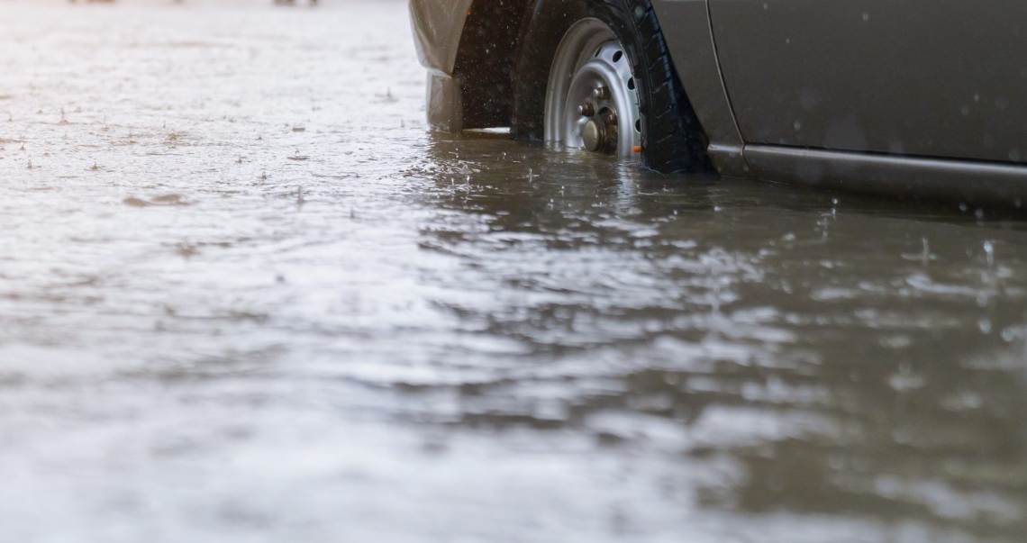 flood water coming up on a car with flood insurance