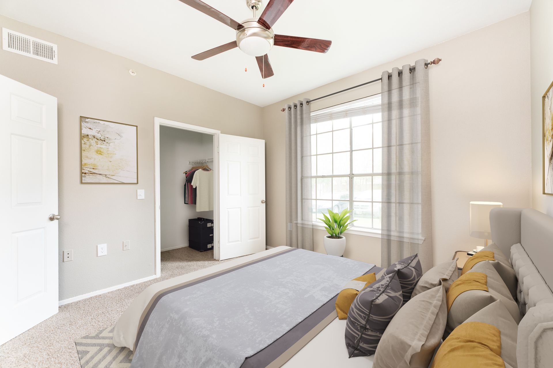 A bedroom with a large bed and a ceiling fan at Marquis Champions Forest offers apartments for rent in Houston, TX.