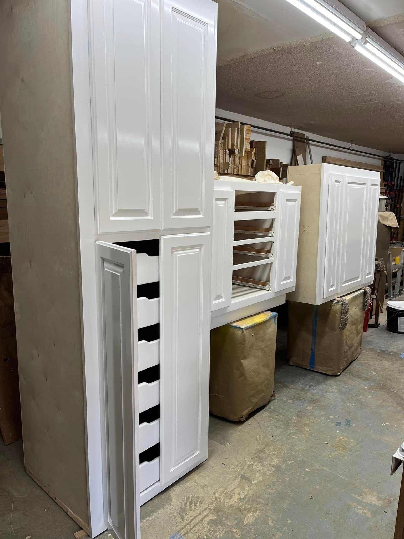 A room filled with lots of white cabinets and boxes.