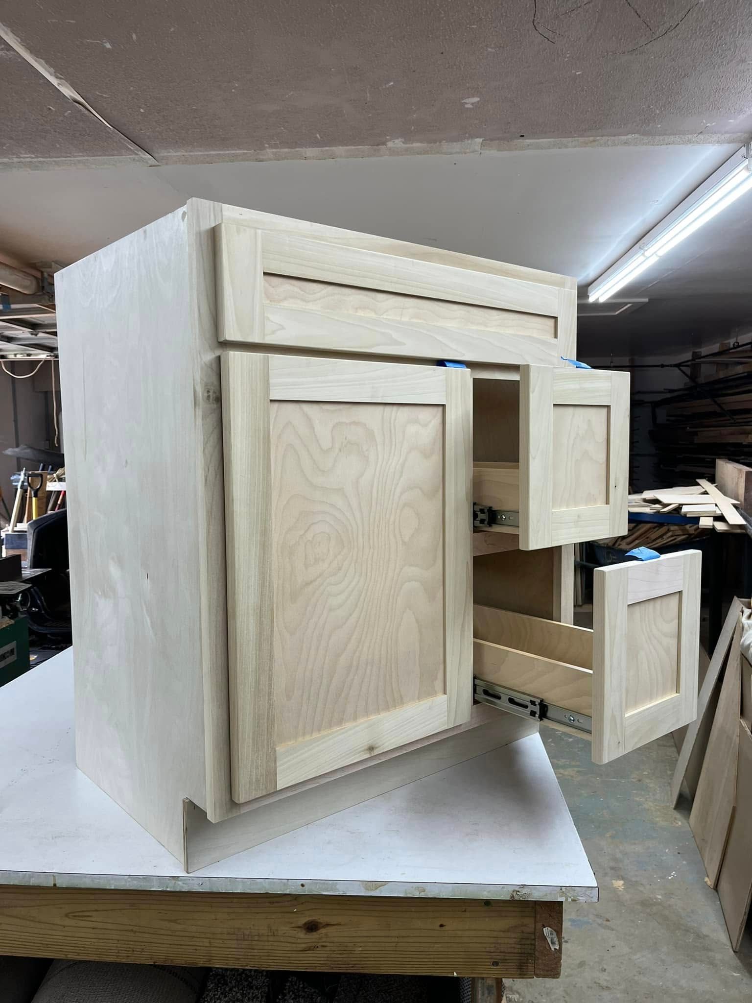 A wooden cabinet is sitting on top of a wooden table.