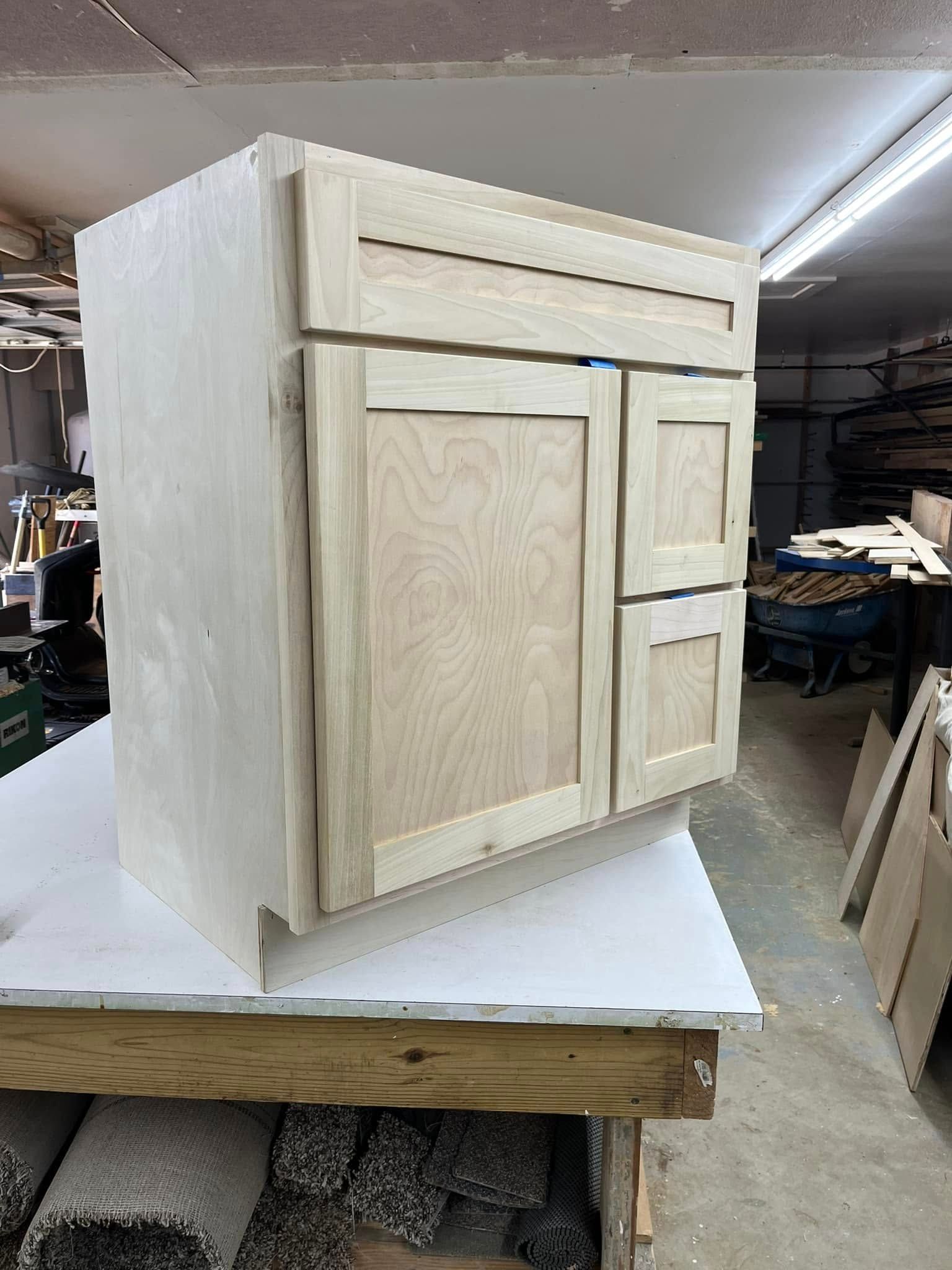 A wooden cabinet is sitting on top of a wooden table.