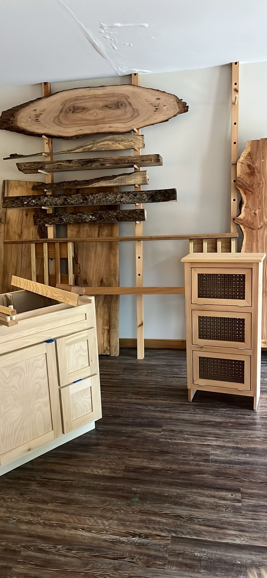 A room with wooden furniture and a large piece of wood on the wall.