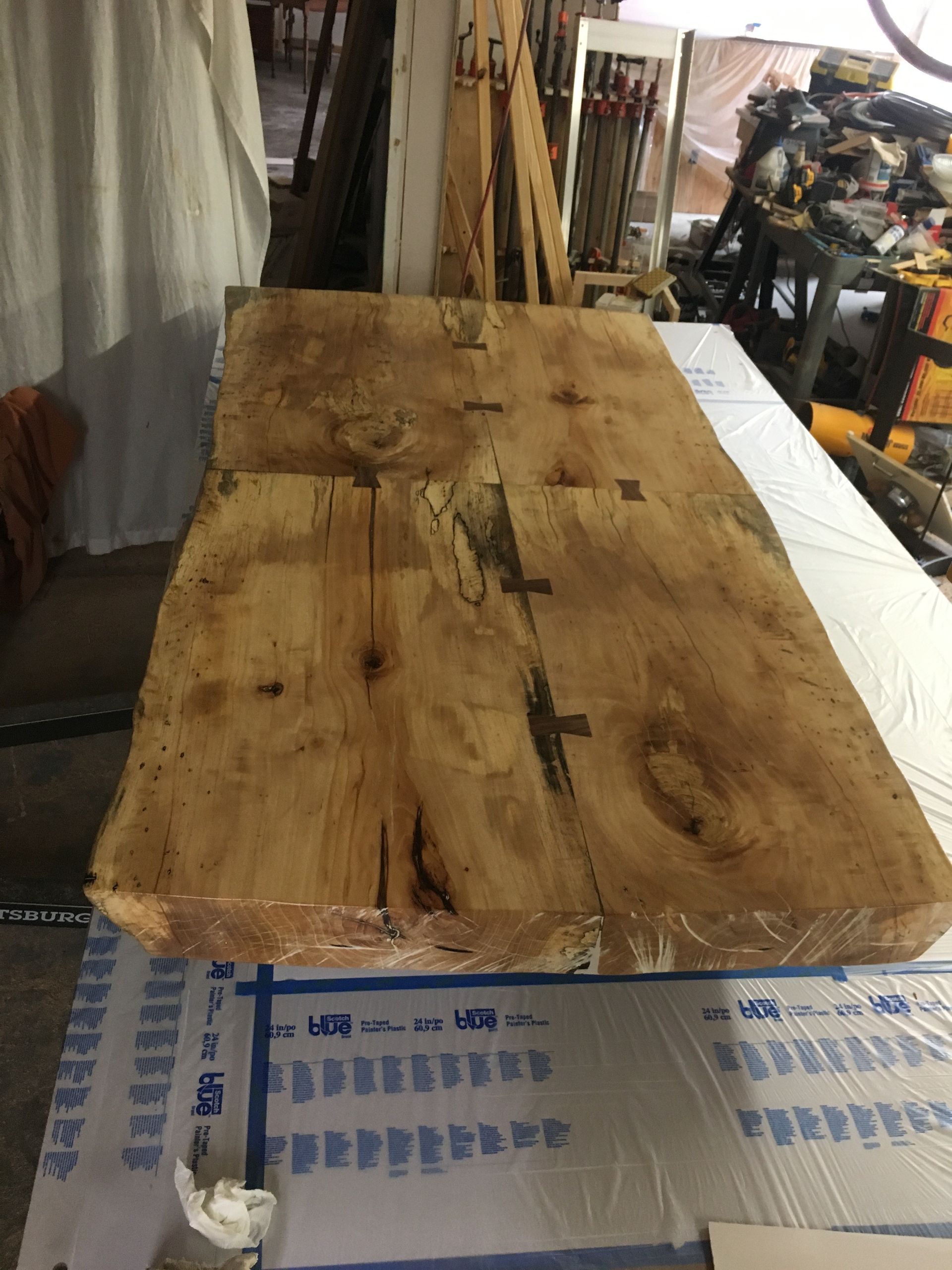 A large piece of wood is sitting on top of a table.