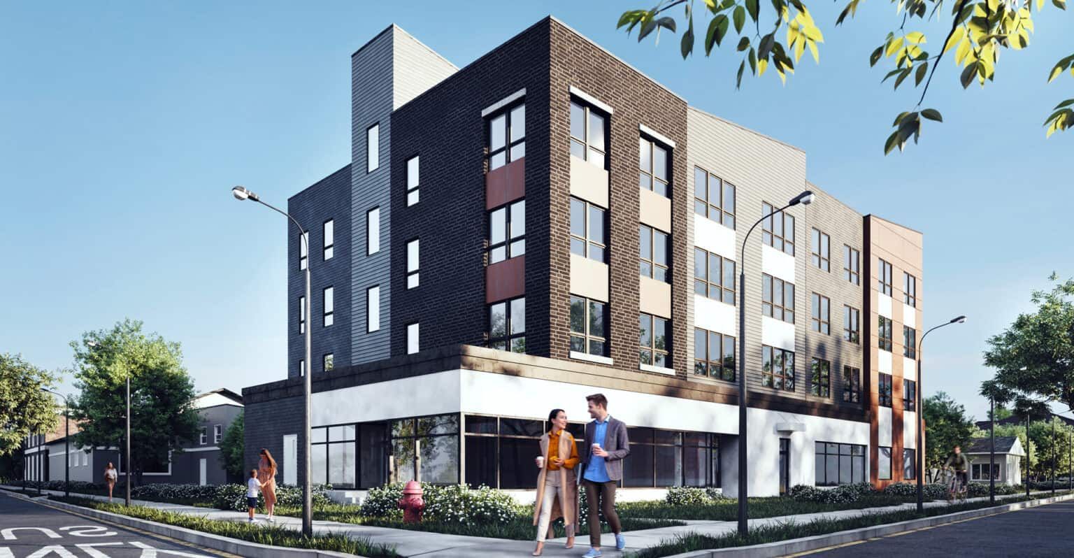 A couple is walking down the sidewalk in front of a large apartment building.