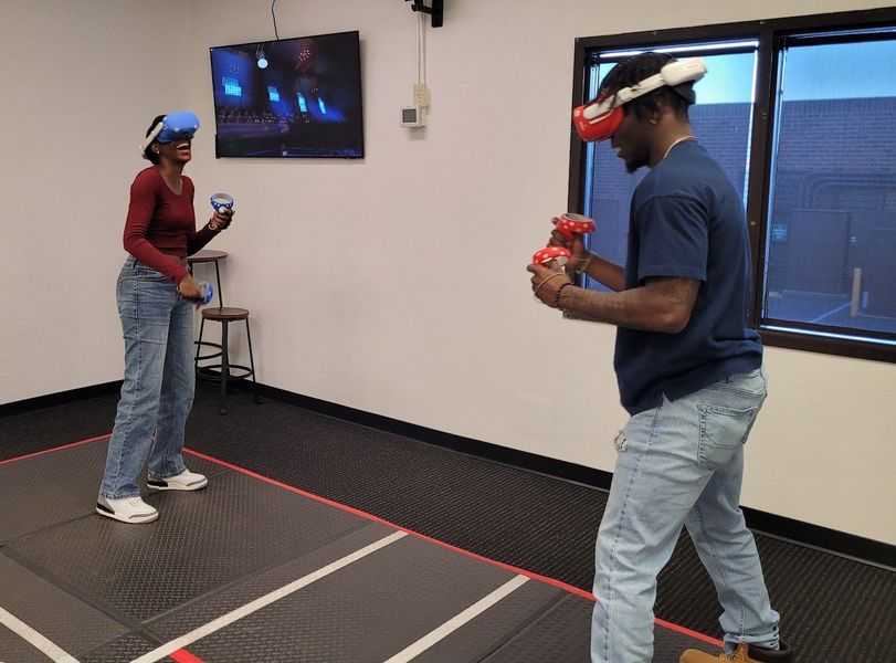 A man and a woman are playing a virtual reality game.