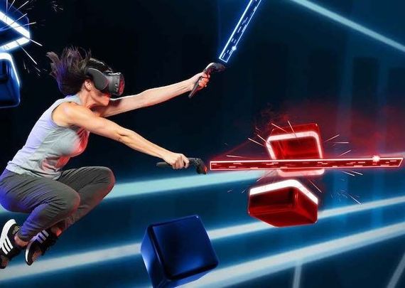 A woman wearing a virtual reality headset is playing a video game.
