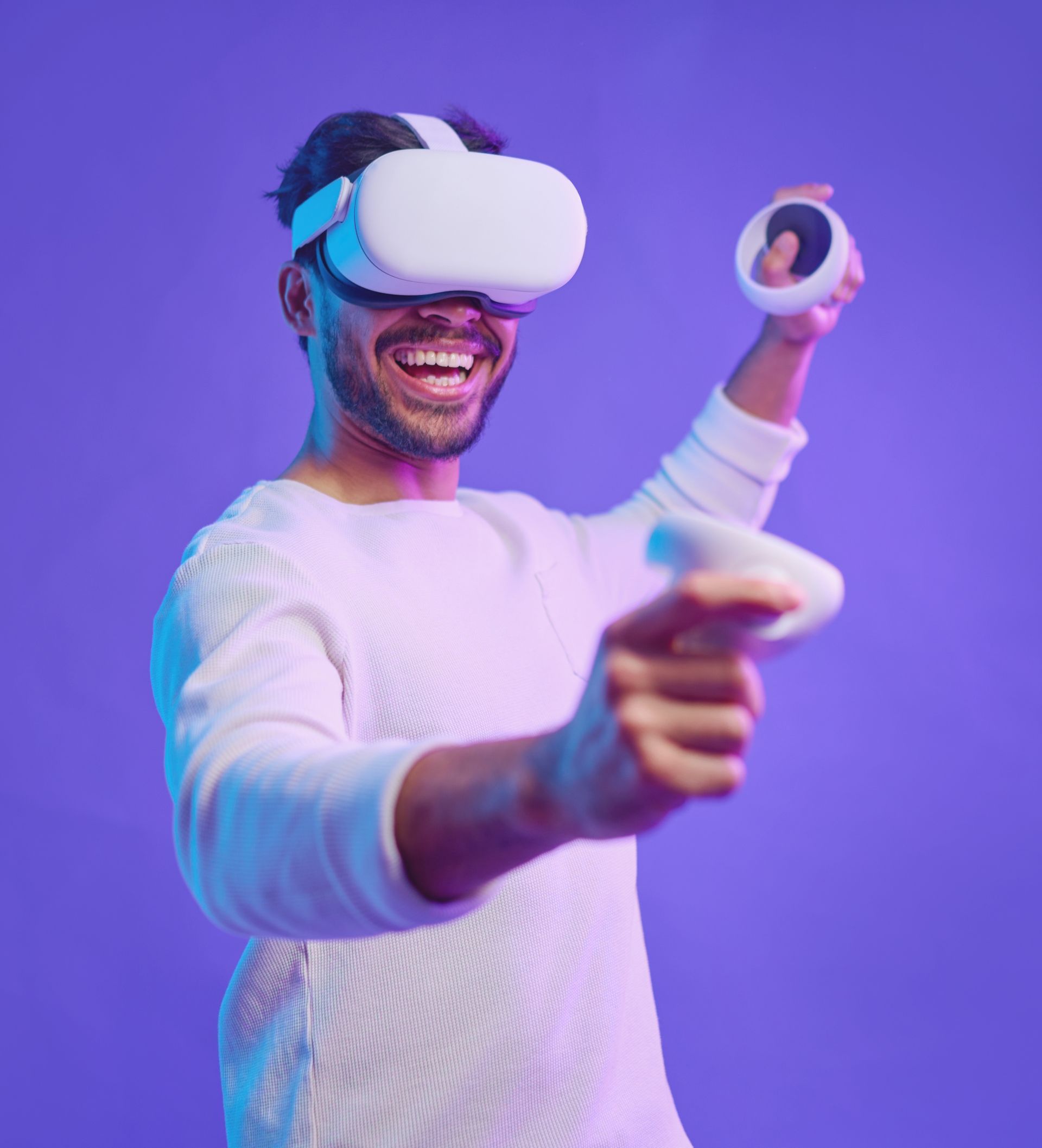A man is wearing a virtual reality headset and holding a controller.