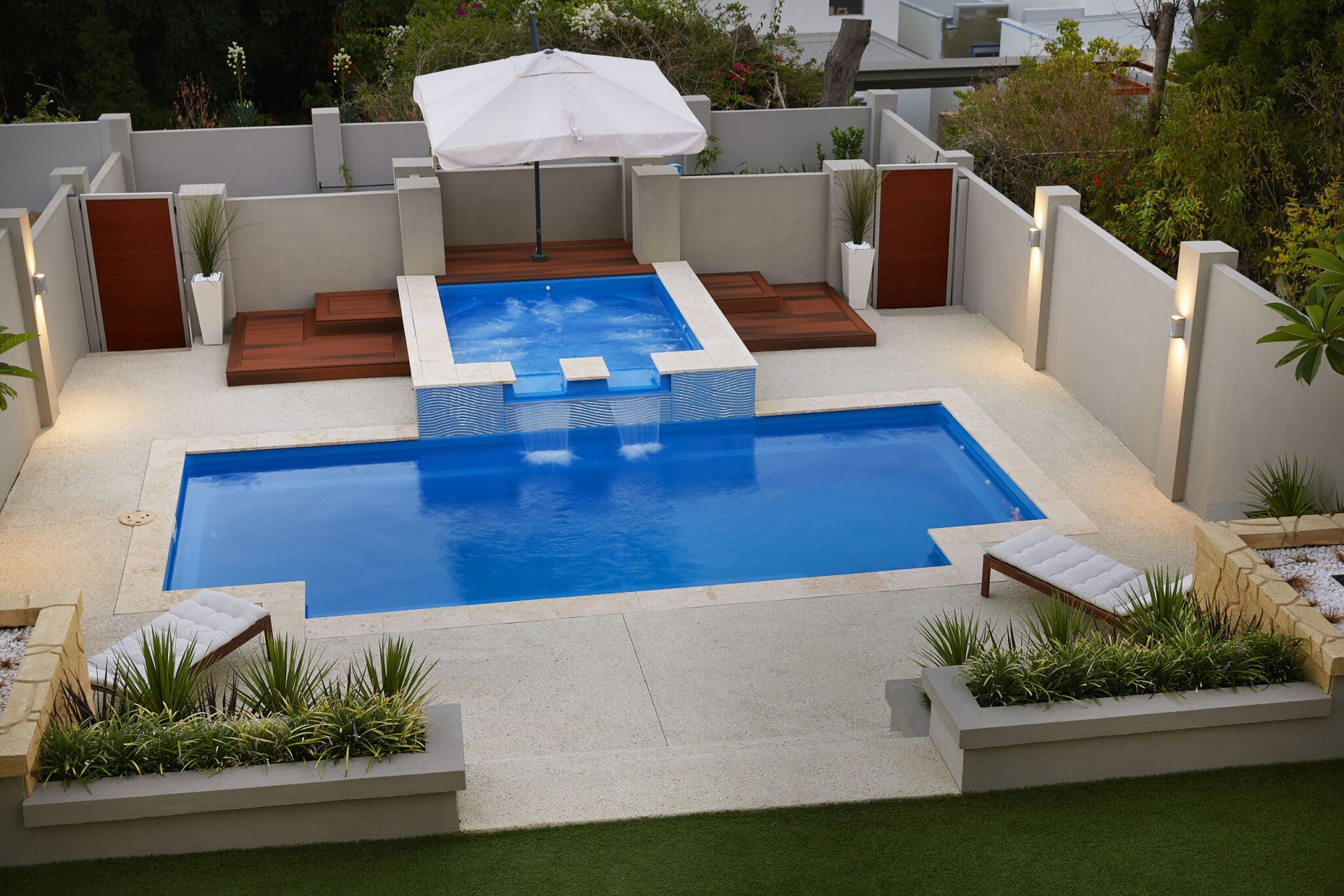 A Large Swimming Pool With A Glass Fence Around It — Gibson Family Pools Pty Ltd In Port Macquarie, NSW