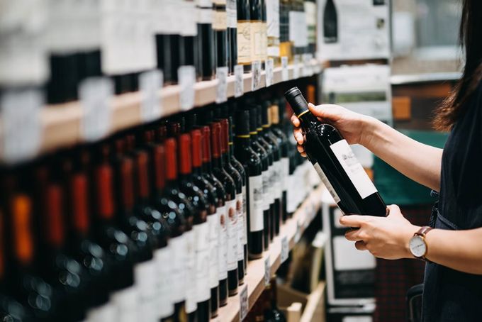 Woman Choosing Wine — Boonville, NY — Wine and Spirits at 130 Main