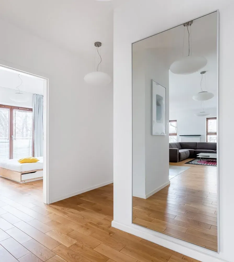 A Large Mirror is Hanging on a Wall in a Hallway — Orana Glass In Dubbo, NSW