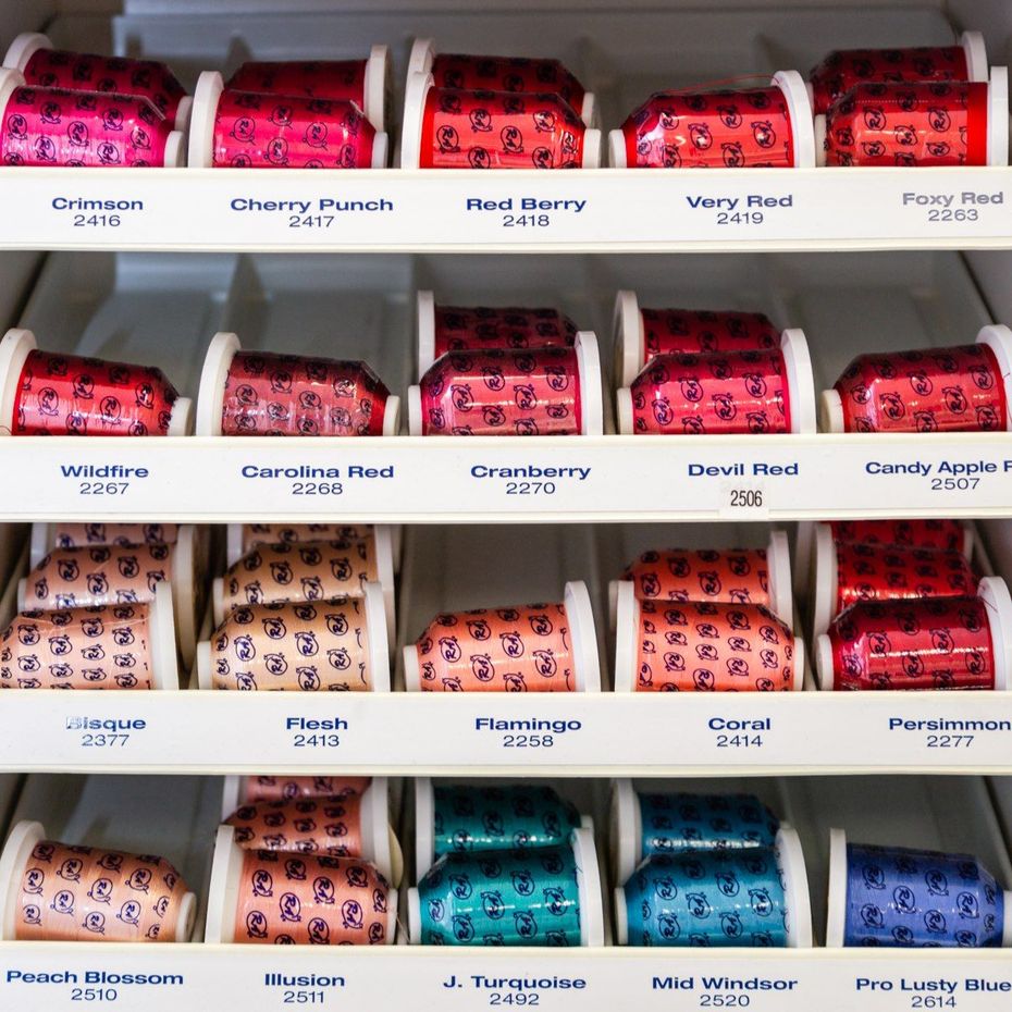 Rows of colorful packaged snack bars on white grocery shelves, labeled by flavor and brand.