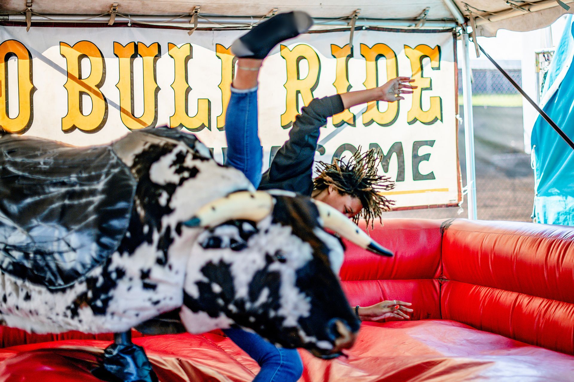 A man is riding a bull at a rodeo.