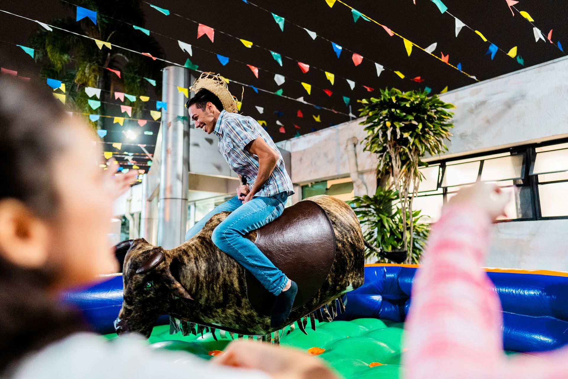 A man is riding a bull at a rodeo.