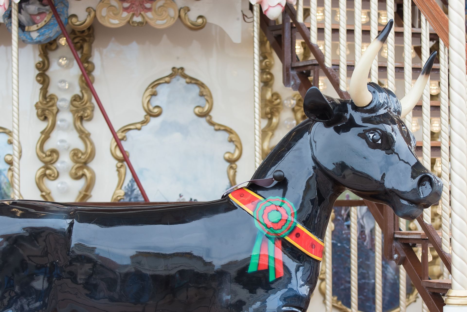 A statue of a bull with horns and a ribbon around its neck
