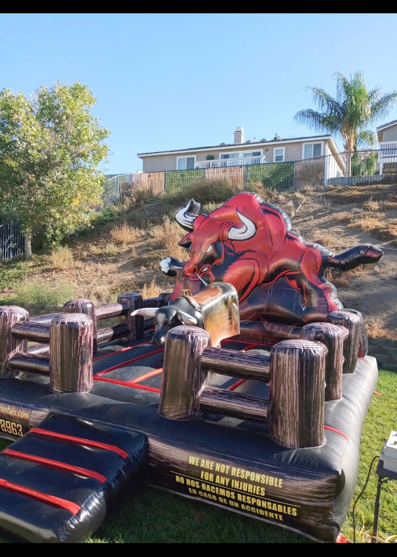 A man is riding a bull at a rodeo.