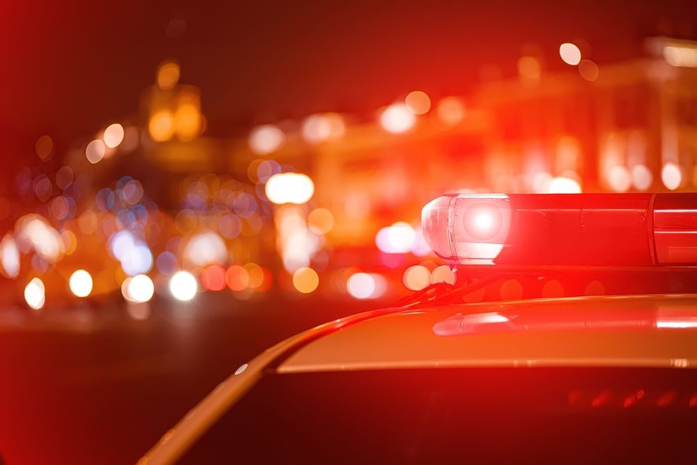 A close up of a police car with a red light on top of it.