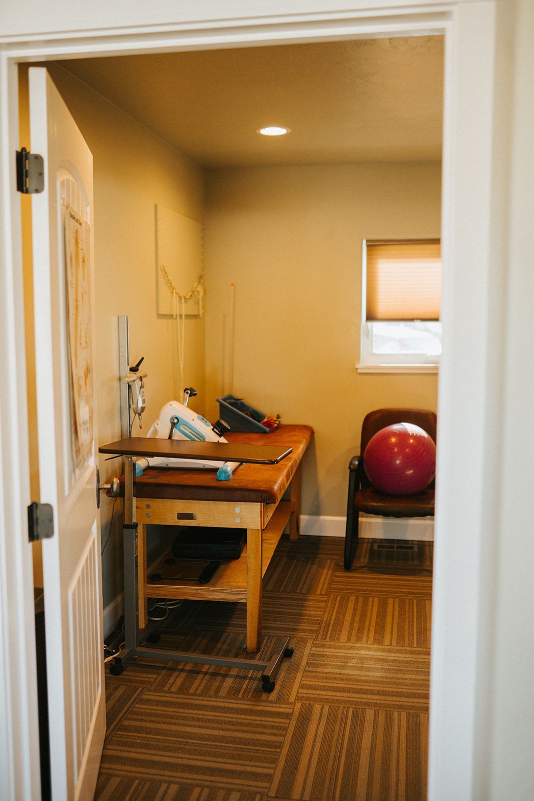 A room with a table and a chair in it.