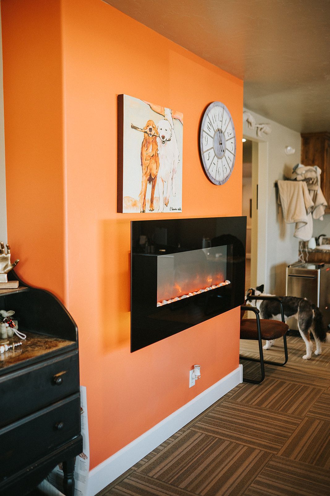A living room with a fireplace and a clock on the wall.