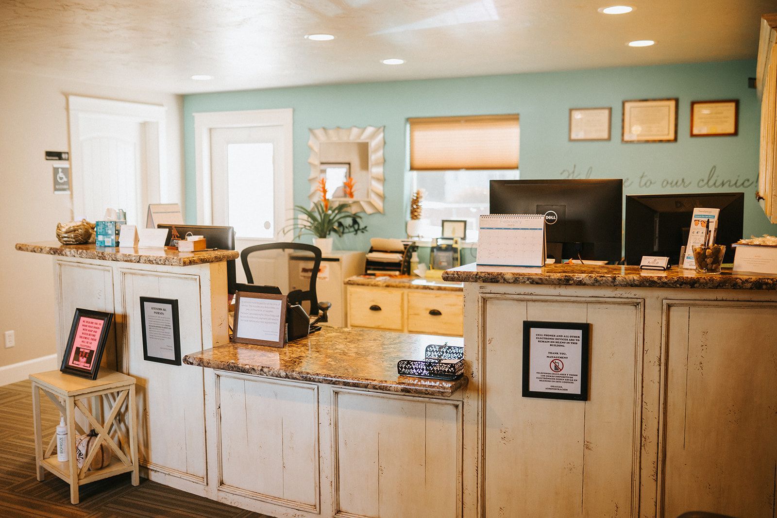 A reception desk in a dental office with a computer on it.