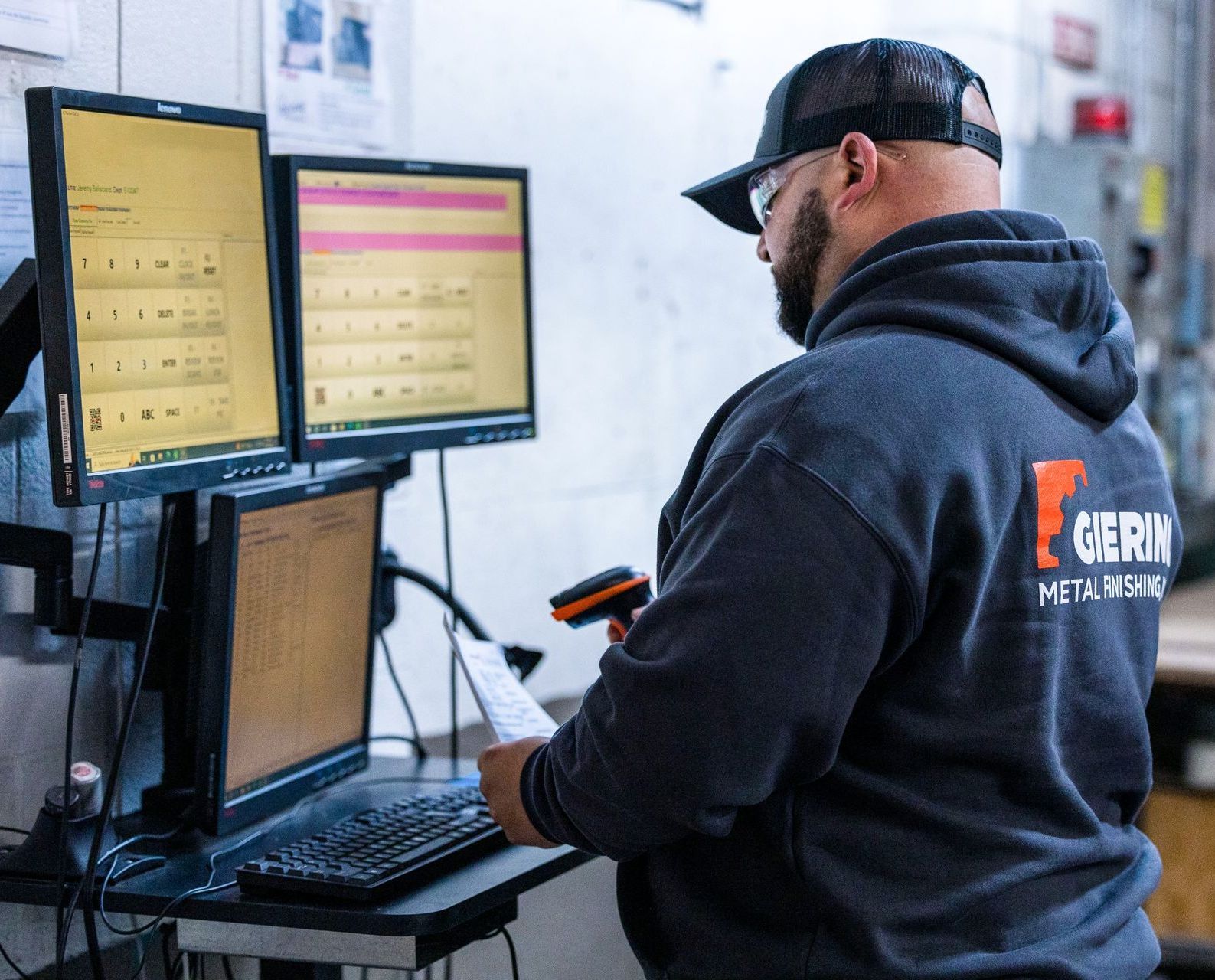 Giering Metal Finishing technician working at a computer station.