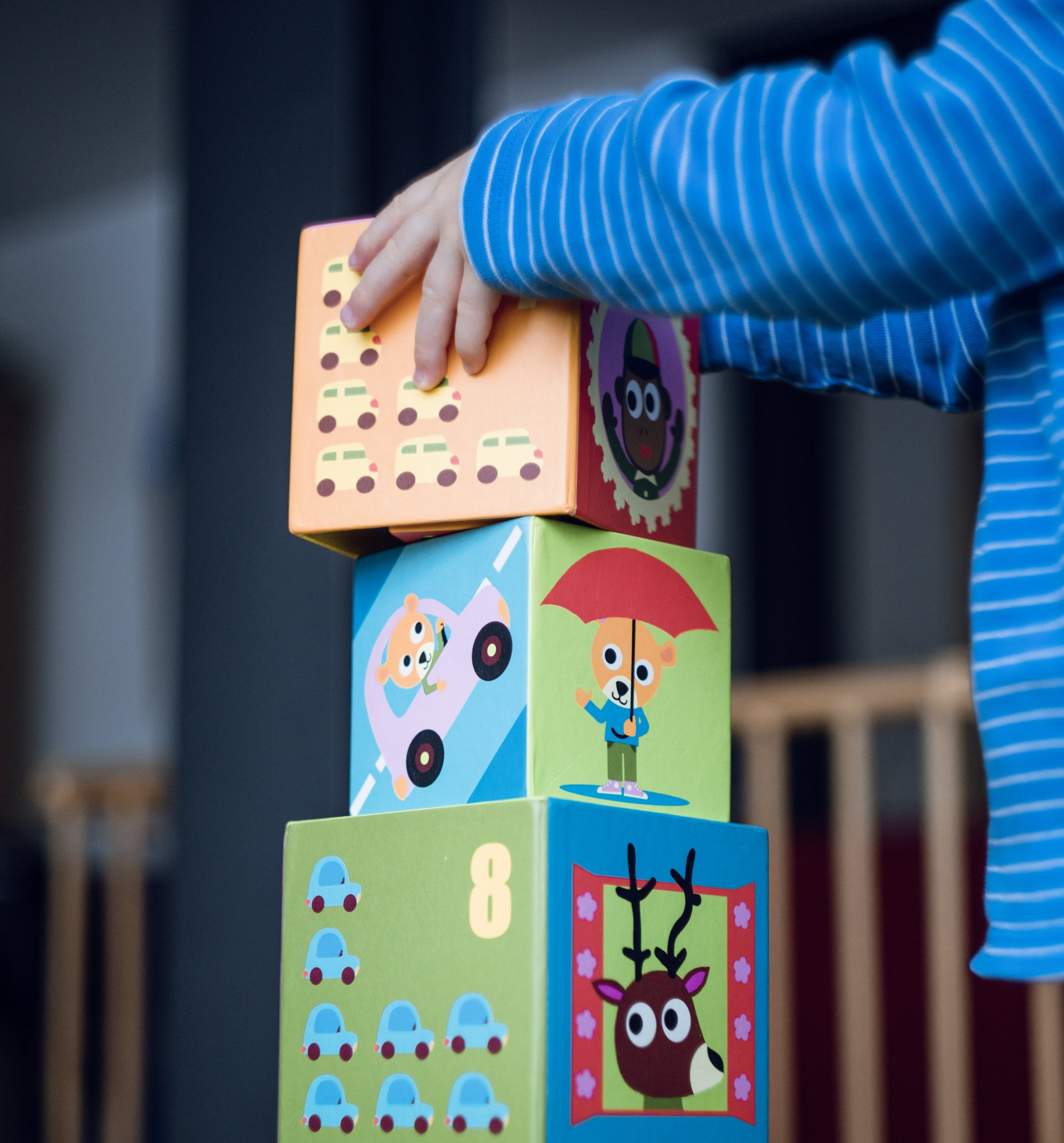 A child playing with colorful blocks, engaging in creative and developmental play.