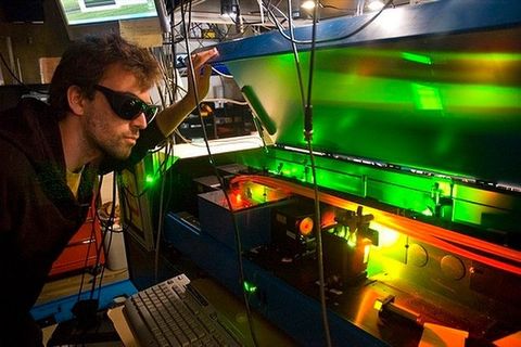 man working in a lab with a laser