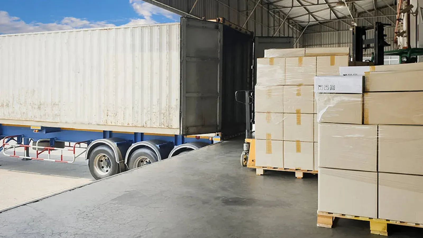 A truck is being loaded with boxes in a warehouse.