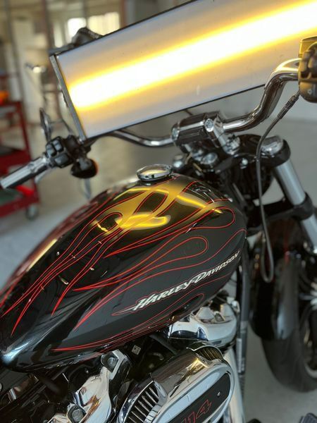 A Harley Davidson Motorcycle Is Sitting in A Garage — Dent Motive in Nerang, QLD