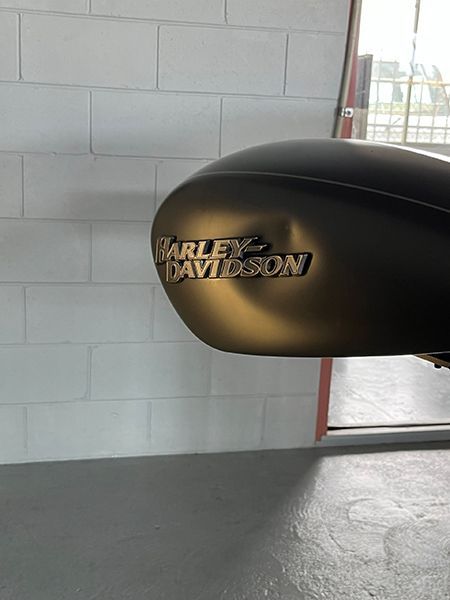 A Harley Davidson Motorcycle Is Parked in A Garage — Dent Motive in Nerang, QLD