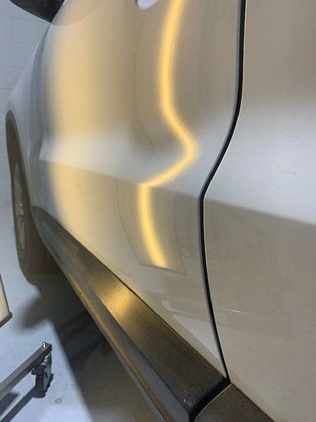 A Close-up Of a Car Door with A Dent in It — Dent Motive in Nerang, QLD