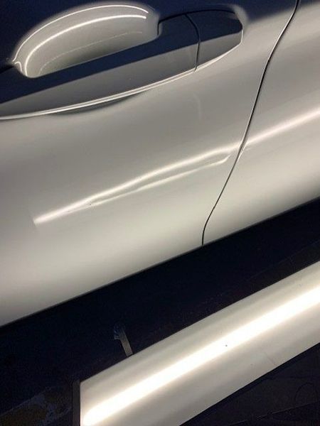 A Close-up Of a White Car with A Broken Door Handle — Dent Motive in Nerang, QLD