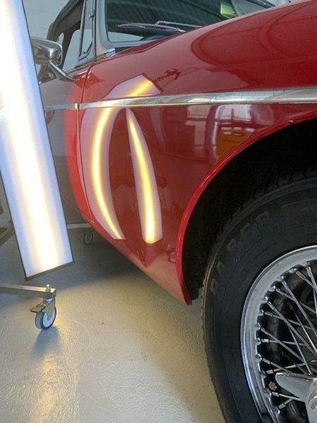 A Close-up Of a Red Car with A Light on It — Dent Motive in Nerang, QLD