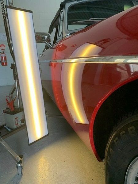 A Red Car with A Tire — Dent Motive in Nerang, QLD